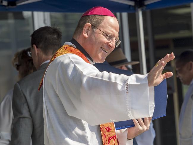 Bishop Anthony Randazzo waves to students during the opening Our Lady of the Rosary Catholic Primary School's new learning centre at Wyoming. Picture: Troy Snook