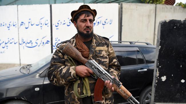 A Taliban fighter stand guards along a roadside in Jalalabad. Picture: AFP