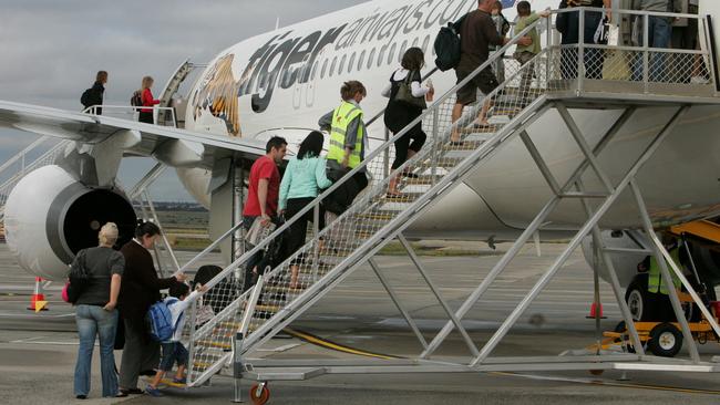 23 Nov 2007 Passangers board the first Tiger flight. Tiger Airways takes off at Melbourne Airport. Flight TT7402 to the /Gold /Coast, it was the first flight to depart from its home of Melbourne Airport. aviation aircraft airlines plane jet