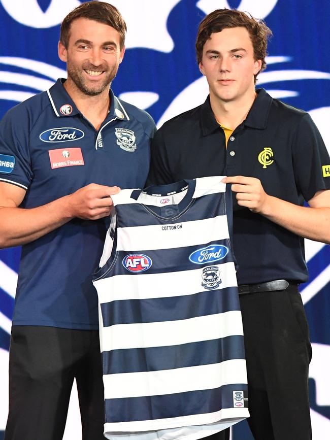 Clark receives his new Geelong guernsey from club great Corey Enright.