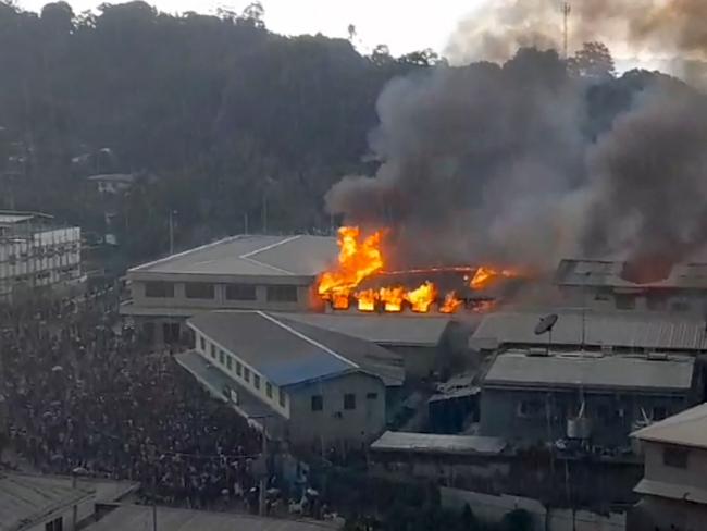 Vision from ZFM Radio shows parts of the Chinatown district on fire in Honiara.