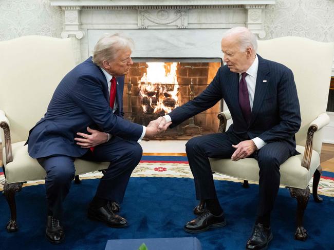 US President Joe Biden shakes hands with US President-elect Donald Trump during a meeting in the Oval Office of the White House in Washington, DC, on November 13, 2024. (Photo by SAUL LOEB / AFP)