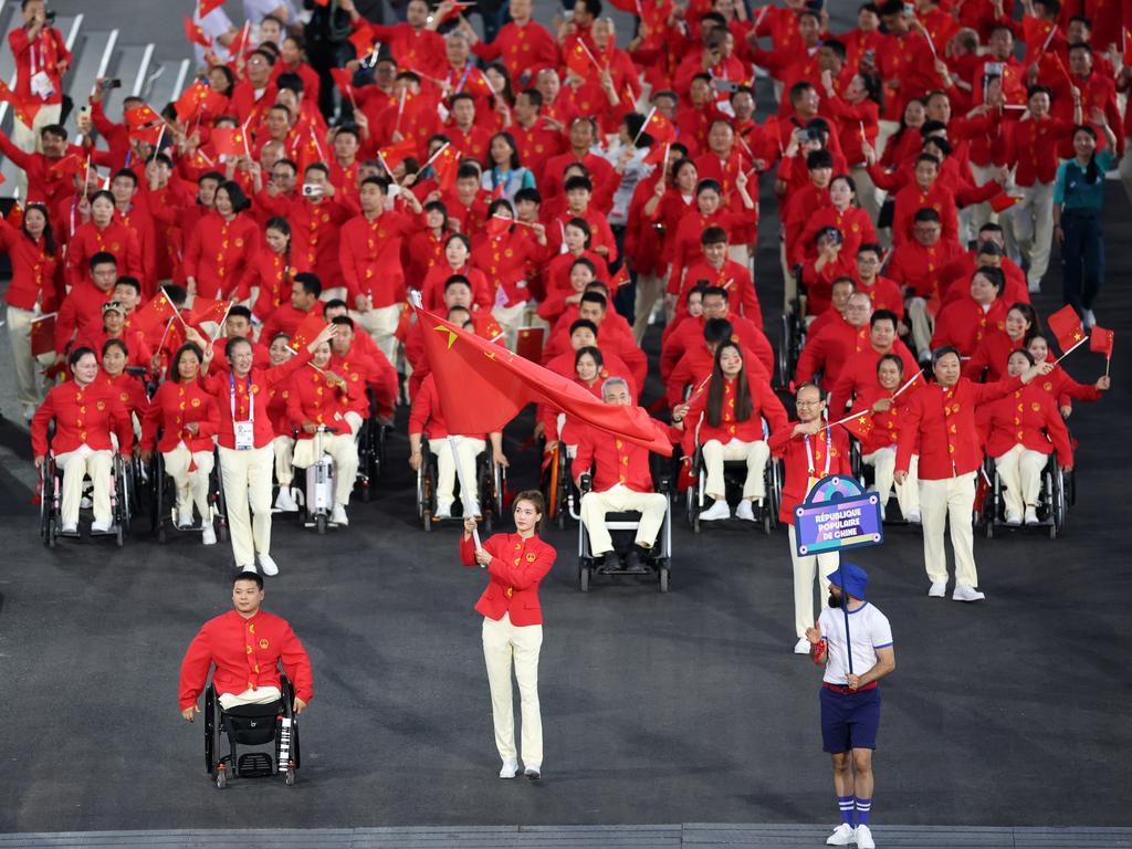 Haiyan Gu and Yongkai Qi, Flag Bearers of Team China, hold their national flag as they parade, part of another strong delegation from the Paralympics powerhouse nation. Picture: Elsa/Getty Images