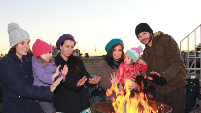 Jessica Parry, Reesar Shailer, Sarah Parry, Mel Shelf, Jazmine Shelf and Andrew Shelf warm up around one of the fire drums at the Killarney Memorial Age Care Centre Bonfire night Saturday, July 19, 2014. Photo John Towells / Warwick Daily News