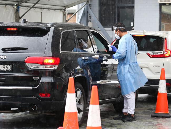 SYDNEY, AUSTRALIA - NewsWire Photos, DECEMBER 23 2021: Health professionals are seen working at the Haberfield Drive through Covid-19  testing clinic as testing demand surges ahead of the holidays in Sydney. Picture: NCA NewsWire / Gaye Gerard