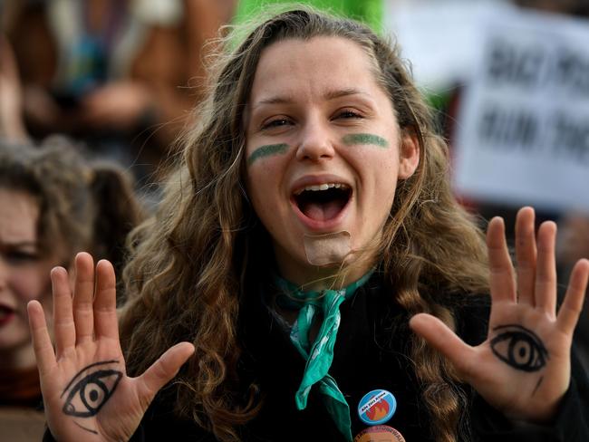 A demonstrator takes part in a protest on climate emergency, called by environmental groups including Extinction Rebellion and Fridays For Future, outside the UN Climate Change Conference COP25 at the 'IFEMA - Feria de Madrid' exhibition centre, in Madrid, on December 13, 2019. - The preservation of Earth's pristine wildernesses and oceans, long treated as a separate issue to curbing climate change, is taking on more importance as scientists say they really need to go hand in hand. While the focus at COP25 in Madrid these past two weeks has been on climate change and the growing urgency to cut greenhouse gas emissions, organisers have made an effort to put the natural environment into the mix. (Photo by PIERRE-PHILIPPE MARCOU / AFP)