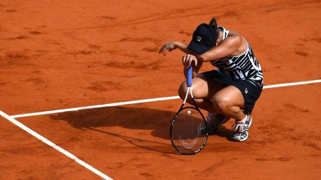 Ash Barty celebrates winning her maiden grand slam title.