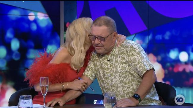 Carrie shares a hug with pannelist Steve Price.