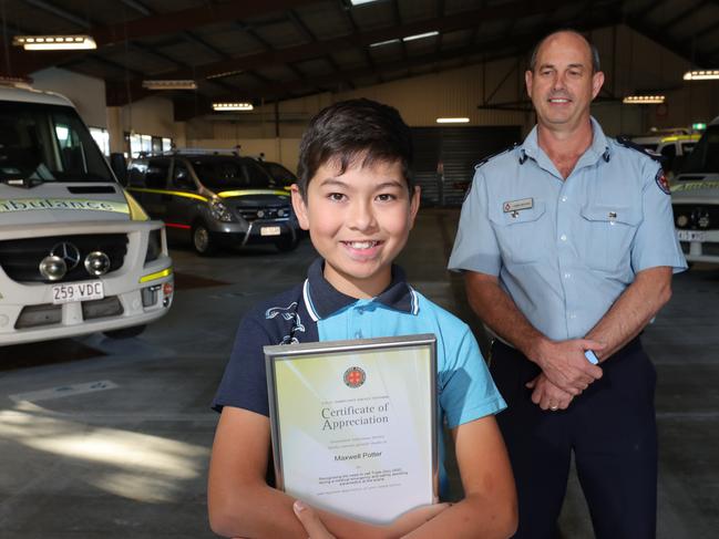 Eleven year old Maxwell Potter with his certificate of appreciation and Assistant Commissioner Chris Draper at Southport Ambulance Station.  Leslie Potter suffered a life-threatening onset of asthma at his Runaway Bay home and was left in severe respiratory distress and unable to communicate. LeslieÃs  son Max recognised the emergency and called Triple Zero . Picture Glenn Hampson