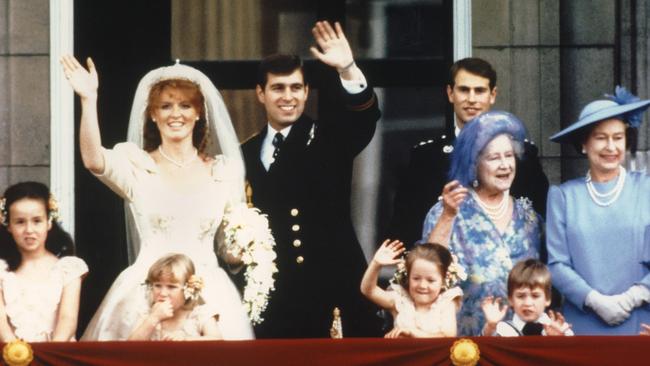 The newly wed Prince Andrew, the Duke of York and his wife Sarah Ferguson, the Duchess of York, wave to crowds from the balcony of Buckingham Palace in London in 1986. Picture: AFP