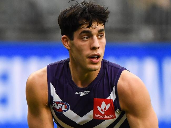 PERTH, AUSTRALIA - AUGUST 08: Adam Cerra of the Dockers looks at his options during the 2021 AFL Round 21 match between the Fremantle Dockers and the Brisbane Lions at Optus Stadium on August 8, 2021 in Perth, Australia. (Photo by Daniel Carson/AFL Photos via Getty Images)