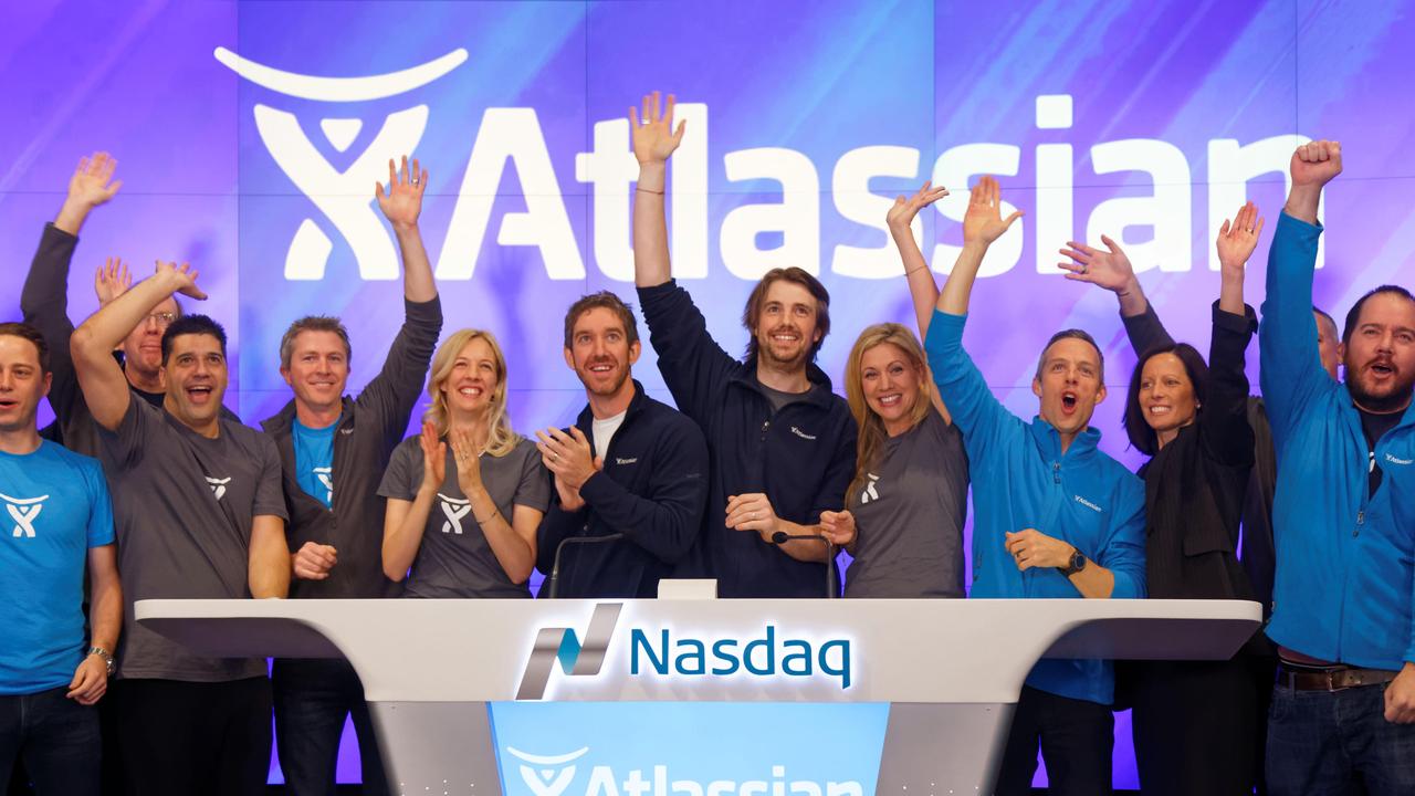 Atlassian co-founders Scott Farquhar (left) and Mike Cannon-Brookes with their families