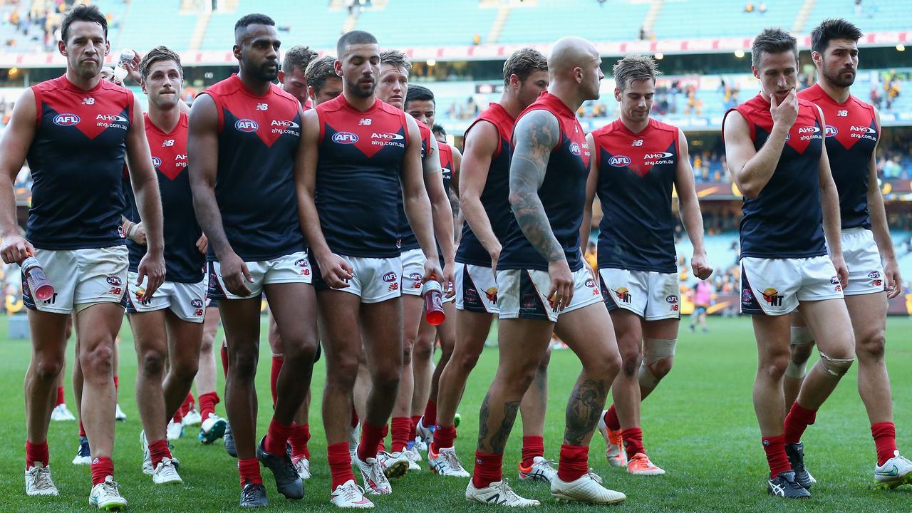 MELBOURNE, AUSTRALIA - MAY 16: The Demons look dejected as they leave the field after losing the round seven AFL match between the Hawthorn Hawks and the Melbourne Demons at Melbourne Cricket Ground on May 16, 2015 in Melbourne, Australia. (Photo by Quinn Rooney/Getty Images)