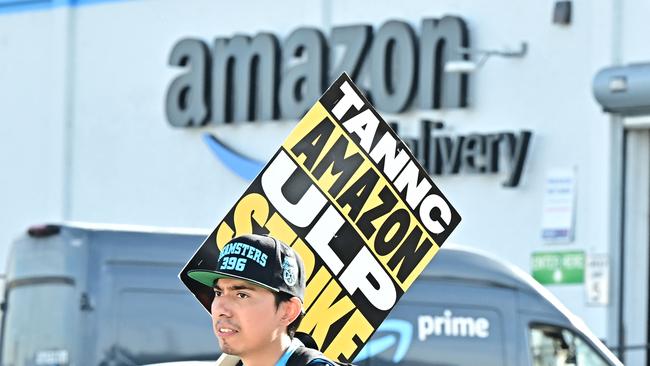 Amazon workers walk the picket line outside an Amazon facility in the City of Industry, California on December 19, 2024. Thousands of workers at Amazon facilities across the United States went on strike December 19, 2024, the Teamsters Union said, halting work at the height of the busy holiday gift-giving season. (Photo by Frederic J. BROWN / AFP)