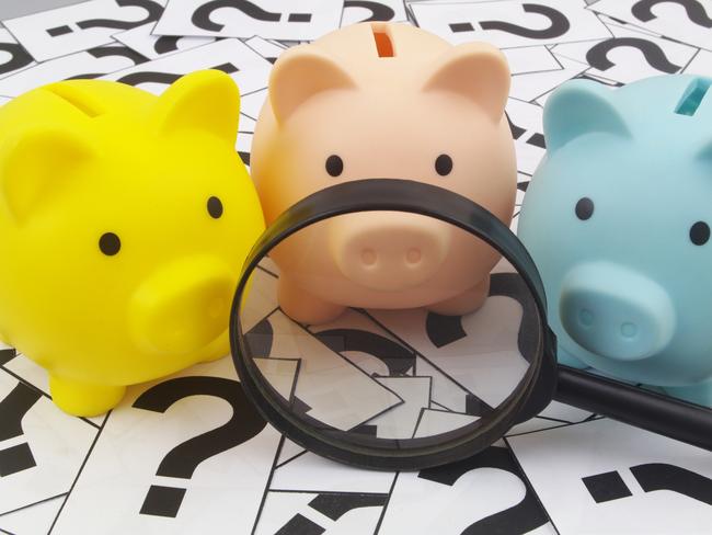 Three piggy banks under magnifying glass on question marks background. Saving money concept; superannuation saving generic