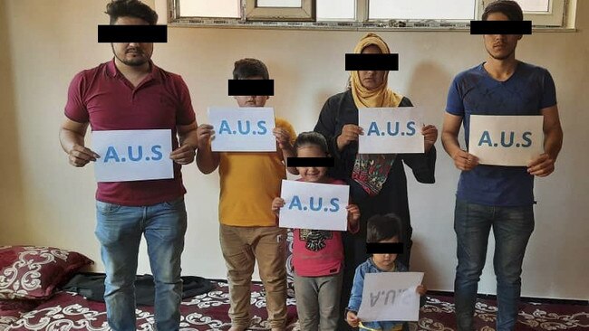 Ehmad and his family pose for a photo that will be used to help spot them in the crowd. Source: Supplied