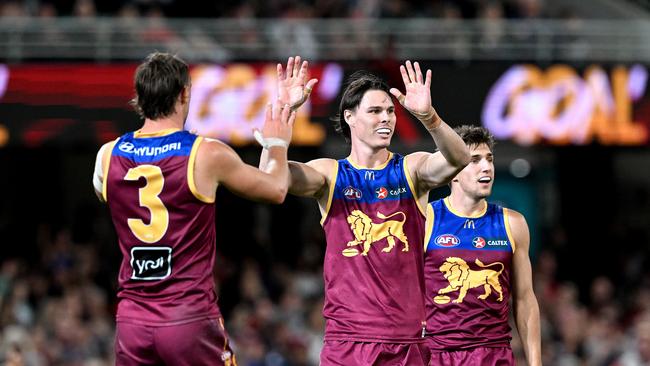 Eric Hipwood (centre) and Joe Daniher (left) celebrate following a Lions goal. Picture: Bradley Kanaris/Getty Images