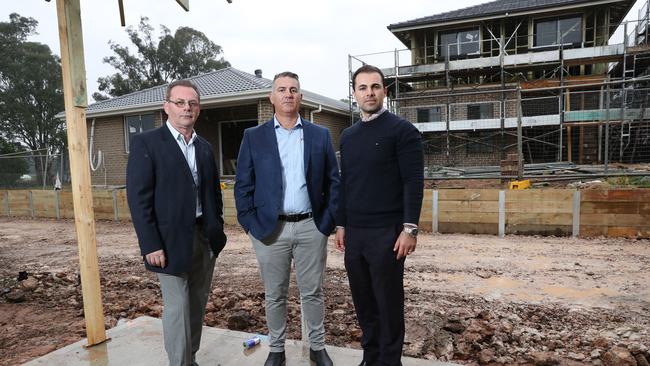 Pictured in Leppington in western Sydney at the site of a yet to be finished display home village is Romeo Tamburri, Emilio Raco and Antonio Gerace who hit out over the three-year delay in approval. Picture: Richard Dobson