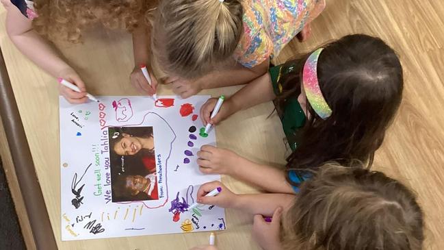 Some kids at the superhero event writing a get-well card to Tahlia. Picture: Tahlia Colbert / Supplied.