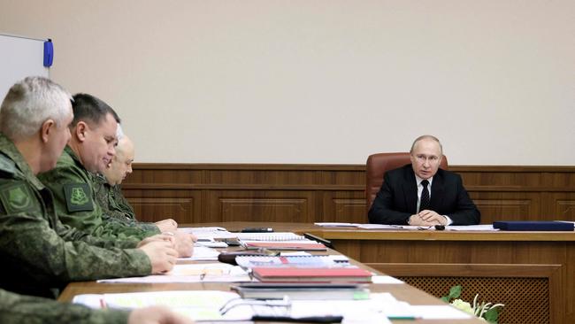 Russian President Vladimir Putin, right, meets with the joint staff of troops involved in Russia's military operation in Ukraine. Picture: AFP