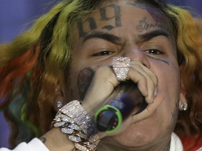 FILE- In this Sept. 21, 2018, file photo rapper Daniel Hernandez, known as Tekashi 6ix9ine, performs during the Philipp Plein women's 2019 Spring-Summer collection, unveiled during the Fashion Week in Milan, Italy. Federal authorities say Hernandez is in custody and awaiting a Manhattan court appearance. The Brooklyn-based rapper, whose legal name is Daniel Hernandez, is among four people arrested on racketeering and firearms charges. (AP Photo/Luca Bruno, File)