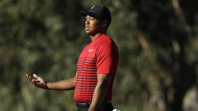 Tiger Woods reacts after missing a putt on the 13th hole of the South Course at Torrey Pines Golf Course during the final round of the Farmers Insurance Open golf tournament, Sunday, Jan. 28, 2018, in San Diego. (AP Photo/Gregory Bull)