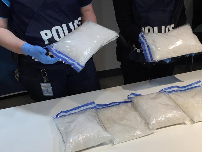 Police hold up bags of ice discovered in a car travelling to Ceduna on Saturday.