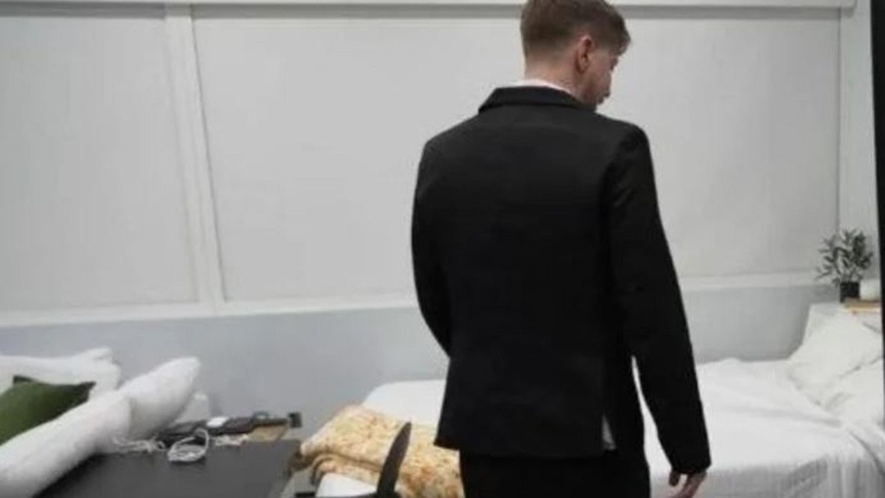 The bed is located in the corner of the living room.