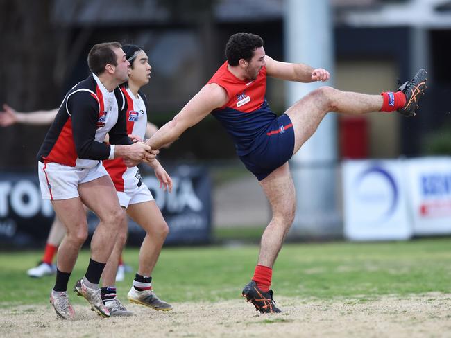 Michael Rogers kicks clear for Bentleigh against St Kilda City. Picture: Steve Tanner