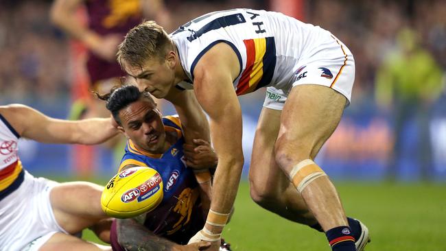 Allen Christensen of the Lions competes with Daniel Talia of the Crows. Picture: AAP Image/Jono Searle