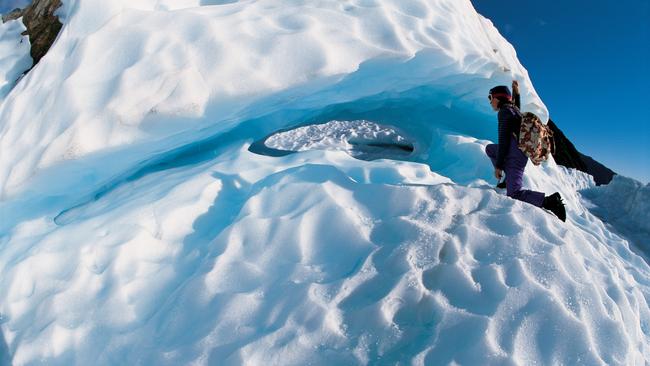 A woman climbs on Fox Glacier before the fires. Picture: supplied