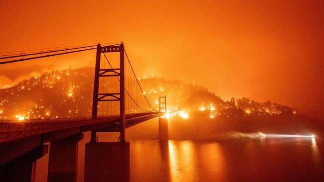 Embers from the Bear fire light up the hillside behind the Bidwell Bar bridge in Oroville, California.