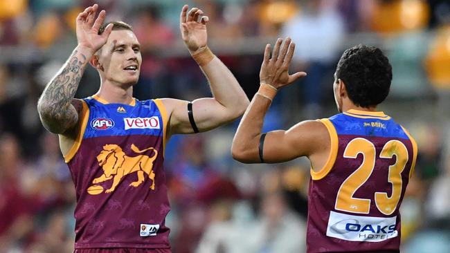 Dayne Beams celebrates a goal with Charlie Cameron.