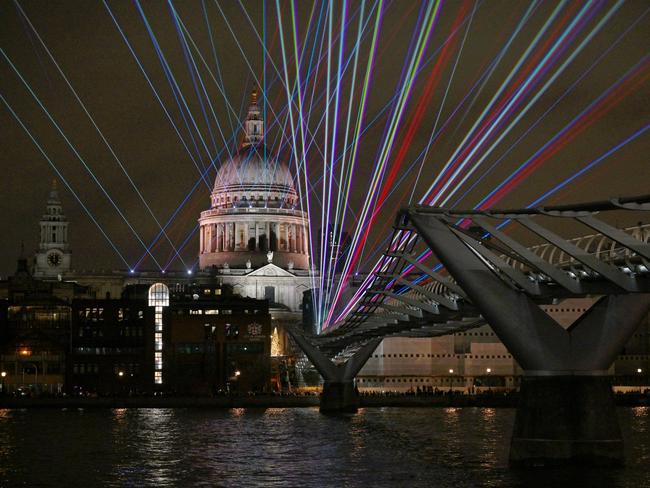 A laser show illuminates on the Millennium Bridge as St. Paul's Cathedral is seen in the background during New Year's Eve celebrations on January 1, 2022 in London, England. Picture: Getty