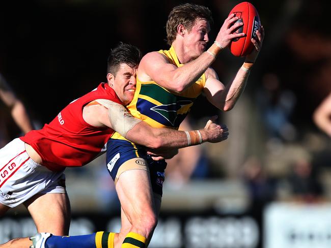 17/05/15 - SANFL, North Adelaide v Woodville-West Torrens. North's Rhys O'Keeffe tackles Eagle Luke Jarrad. Picture Dean Martin