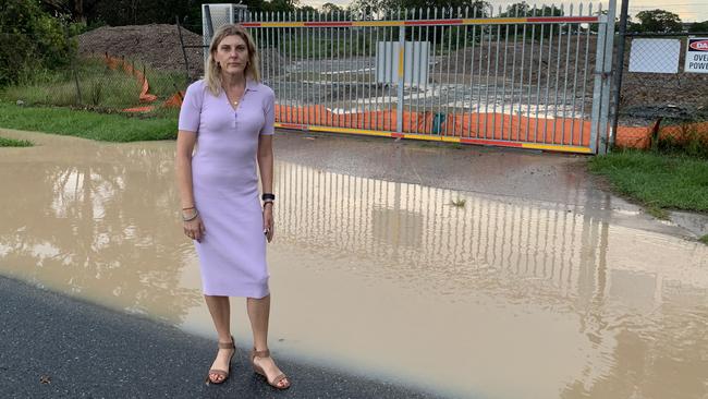 Labor candidate for Doboy Jo Culshaw at the flooded entrance to the Fursden Rd development site.