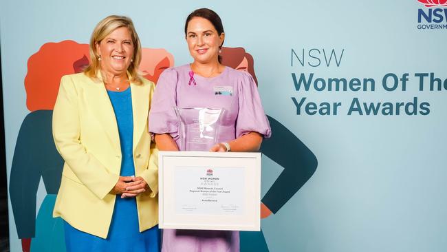 Minister for Women Bronnie Taylor wears the national colours of Ukraine while presenting the Regional Woman of the Year Award to Anna Barwick.