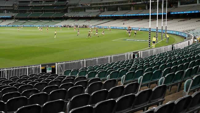 Players compete for the ball as empty seats are seen due to the coronavirus outbreak during the 2020 AFL Round 1 match between the Richmond Tigers and the Carlton Blues at the Melbourne Cricket Ground. (Photo by Michael Willson/AFL Photos via Getty Images)