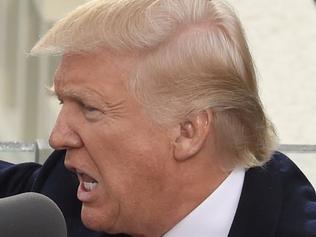 TOPSHOT - US President Donald Trump salutes the crowd after the swearing-in ceremony as 45th President of the USA in front of the Capitol in Washington on January 20, 2017. / AFP PHOTO / Timothy A. CLARY