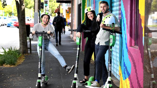 Friends and work colleagues Holly Dundon, Isobel Huisman, and Brice Lawrence ride Lime Scooters in the city. Picture: Tricia Watkinson