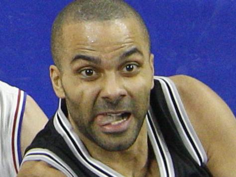 San Antonio Spurs' Tony Parker, center, of France goes up for the shot as he splits the defense of Philadelphia 76ers' Jahlil Okafor, right, and Nik Stauskas, left, during the first half of an NBA basketball game, Monday, Dec. 7, 2015, in Philadelphia. (AP Photo/Chris Szagola)