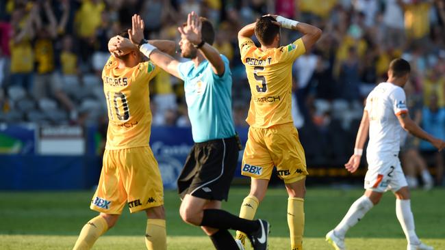 Anthony Caceres and Harry Ascroft of the Mariners react after a goal by Josh Rose was disallowed.