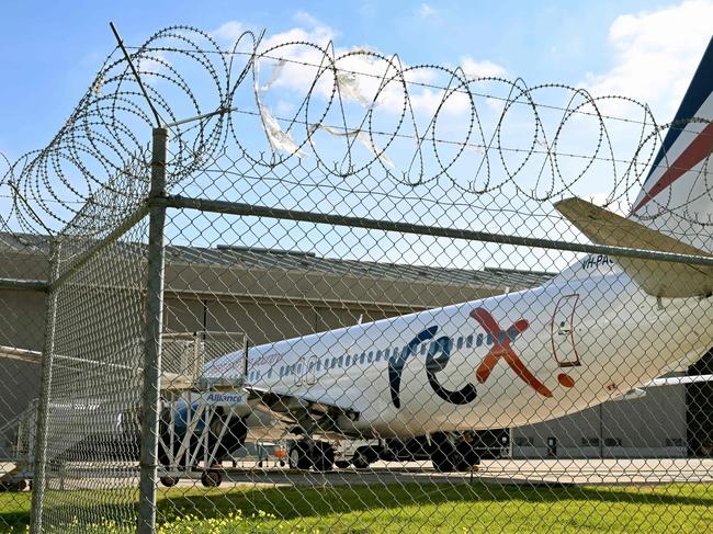 A Rex Airlines Boeing 737 sits on the tarmac at Melbourne's Tullamarine Airport on July 30, 2024 after the Australian regional airline announced a trading halt and thus fuelling speculation of financial challenges. (Photo by William WEST / AFP)