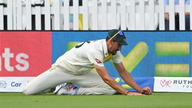 Mitchell Starc uses the hand holding the ball to break his fall. (Photo by Stu Forster/Getty Images)