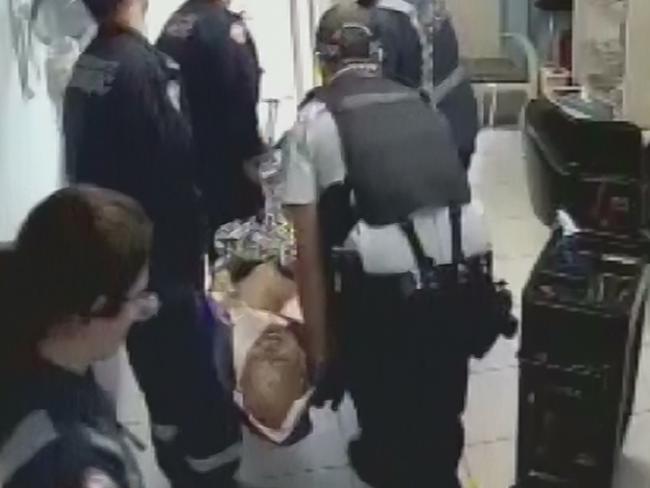 7. Police and paramedics treat a seriously injured Wayne Greenhalgh. Picture: A Current Affair/9NEWS