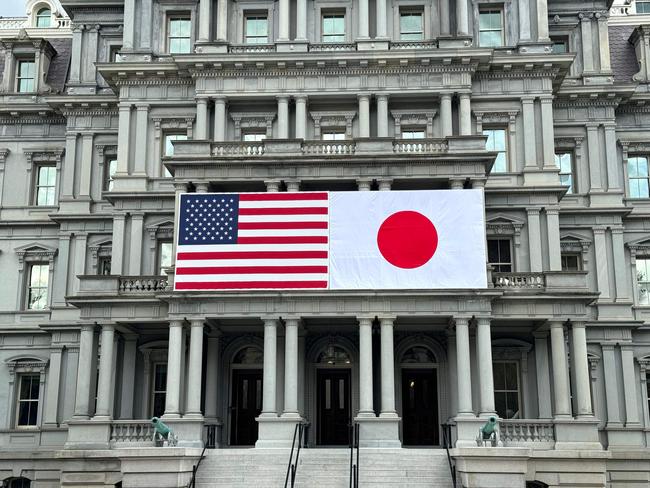 US and Japanese flags are seen posted on the Eisenhower Executive Office Building next to the White House in Washington, DC, on April 5, 2024 in preparation for next week's official state visit of Japanese Prime Minister Fumio Kishida. (Photo by Daniel SLIM / AFP)