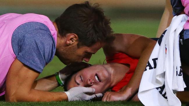 An injured Meg Downie with medical staff after being knocked out against Collingwood. (Photo by Michael Dodge/AFL Media/Getty Images)