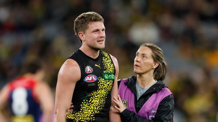 MELBOURNE, AUSTRALIA - APRIL 24: Jacob Hopper of the Tigers is seen to by medical staff during the 2024 AFL Round 07 match between the Richmond Tigers and the Melbourne Demons at the Melbourne Cricket Ground on April 24, 2024 in Melbourne, Australia. (Photo by Dylan Burns/AFL Photos via Getty Images)