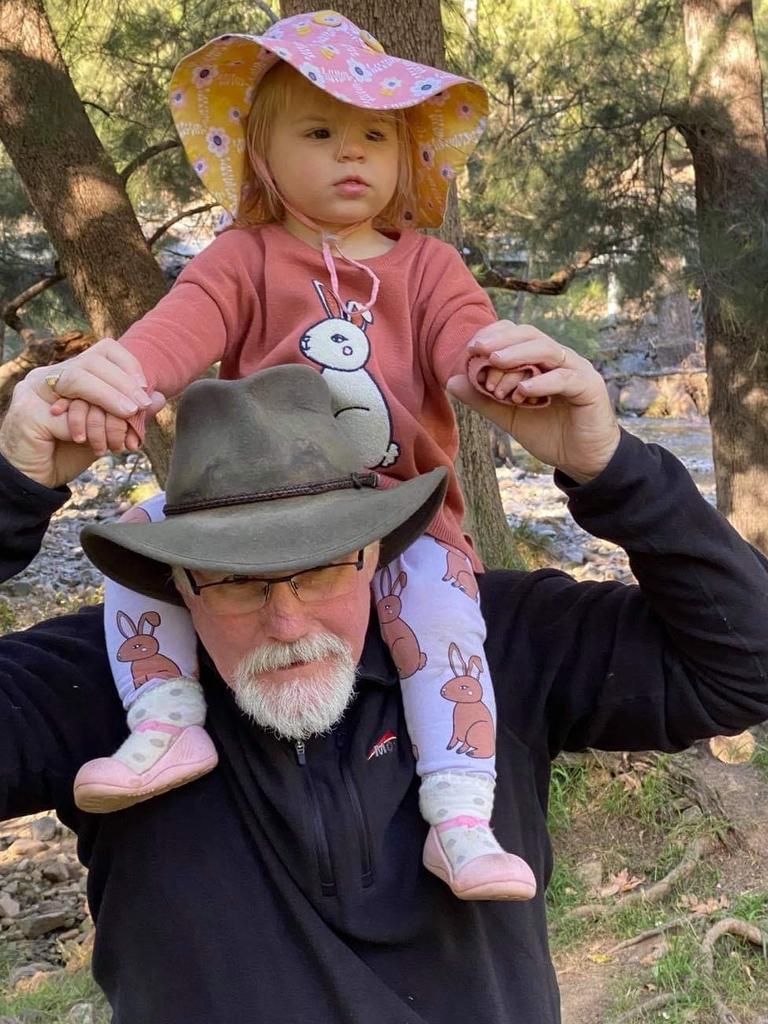 Nigel Harris with his granddaughter Evelyn. The 60-year-old was tragically killed when a vehicle veered off the road and into spectators at the Finke Desert Race on Monday. Picture: Facebook.