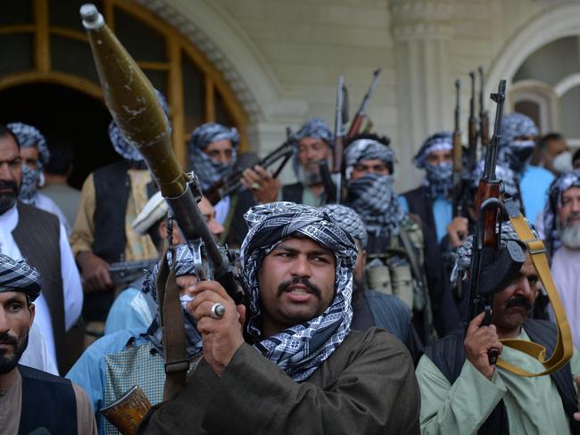 Afghan militia gather with their weapons to support Afghanistan security forces against the Taliban, in Afghan warlord and former Mujahideen Ismail Khan's house in Herat on July 9. Picture: AFP